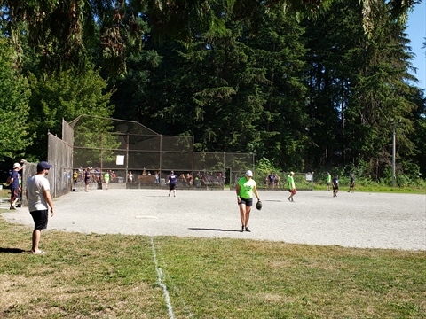 Softball being played at the Brockton Playing Fields in Stanley Park, Vancouver, BC, Canada