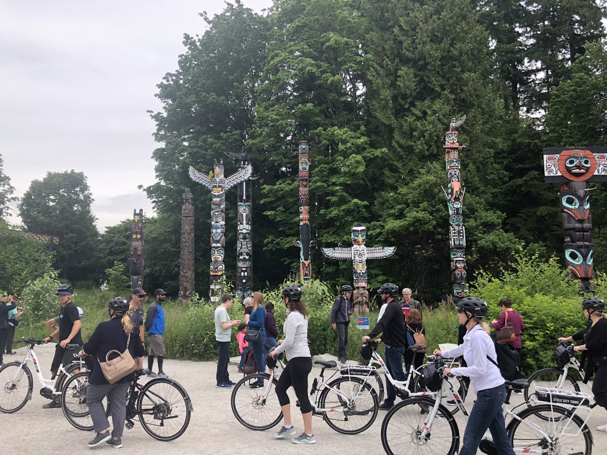 Bicycle tour at Totem Poles in Stanley Park, Vancouver, BC, Canada