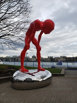 Statue (formerly) on False Creek seawall in Vancouver, BC, Canada